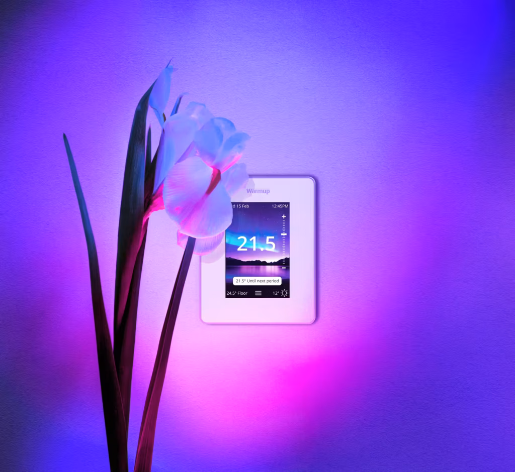 7ie thermostat on a colorful background with white orchid in front