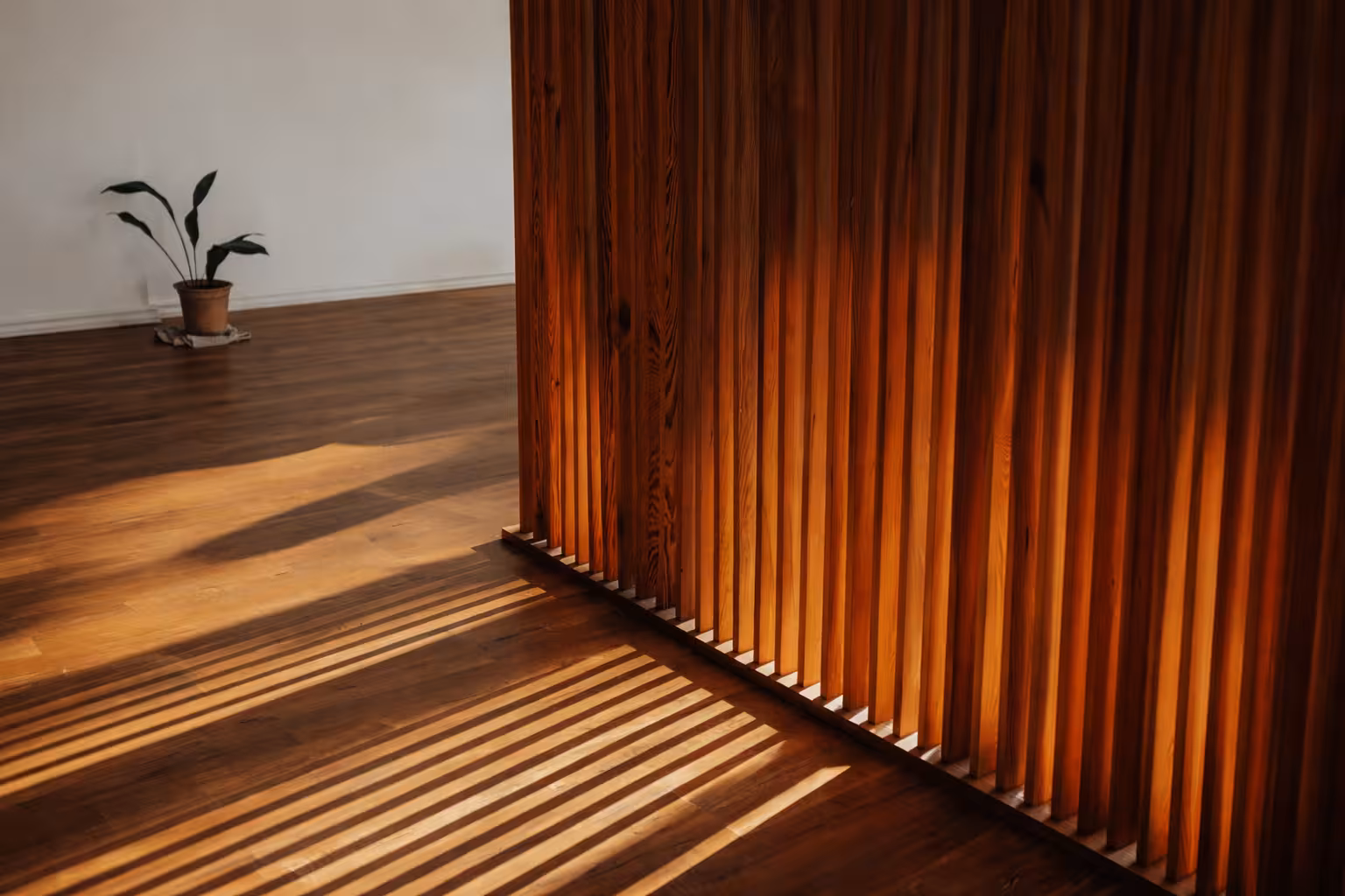 Underfloor heating banner with wood flooring and decorative wooden slats in sunlight